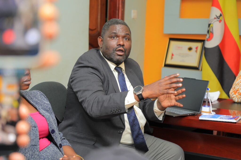 ERA Principal Engagement Officer Ibrahim Kasita explains Uganda’s electricity supply challenges to ONC Manager Hadijah Namyalo Uzeiye during a courtesy visit to the ONC offices in Kyambogo.